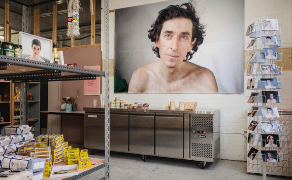 Interior view of shop with large poster of a portrait of a man on the wall